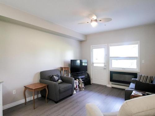 132 8802 Southfort Drive, Fort Saskatchewan, AB - Indoor Photo Showing Living Room With Fireplace