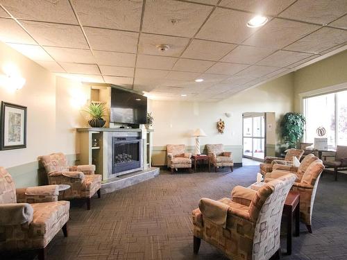 132 8802 Southfort Drive, Fort Saskatchewan, AB - Indoor Photo Showing Living Room With Fireplace