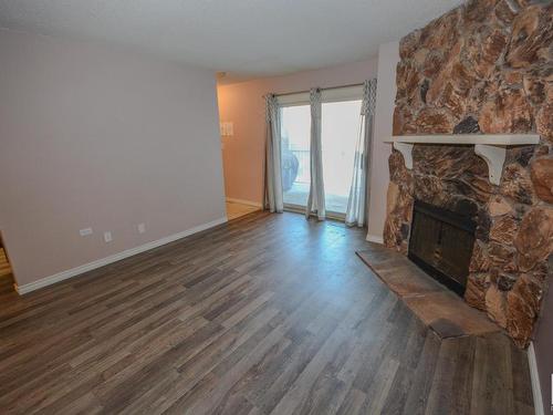 217 10404 24 Avenue, Edmonton, AB - Indoor Photo Showing Living Room With Fireplace