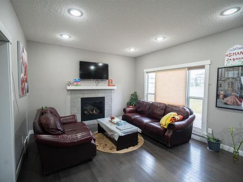 711 57 Street Sw, Edmonton, AB - Indoor Photo Showing Living Room With Fireplace