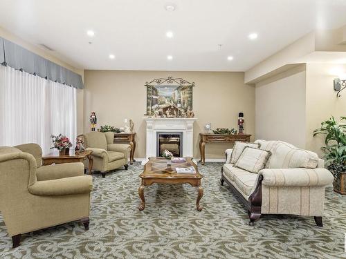 315 9820 165 Street, Edmonton, AB - Indoor Photo Showing Living Room With Fireplace