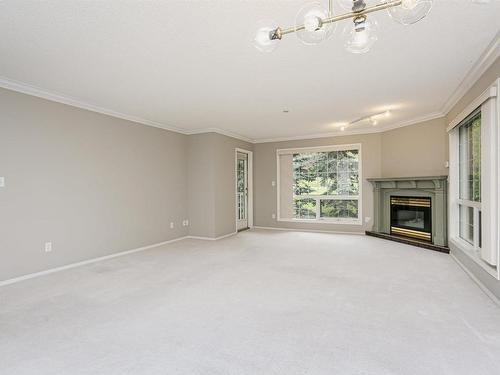 202 20 St Joseph Street, St. Albert, AB - Indoor Photo Showing Living Room With Fireplace