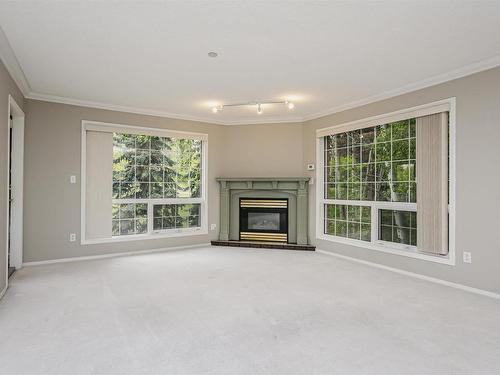 202 20 St Joseph Street, St. Albert, AB - Indoor Photo Showing Living Room With Fireplace