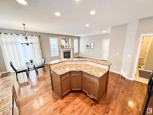 1 1251 Rutherford Road, Edmonton, AB - Indoor Photo Showing Other Room With Fireplace