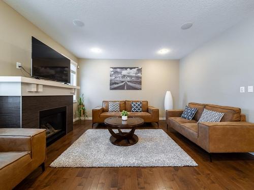 93 Sheppard Way, Leduc, AB - Indoor Photo Showing Living Room With Fireplace