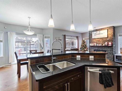 79 Avonlea Way, Spruce Grove, AB - Indoor Photo Showing Kitchen With Fireplace With Double Sink