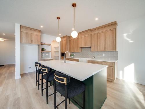 77 Chelles Wynd, St. Albert, AB - Indoor Photo Showing Kitchen With Fireplace With Double Sink