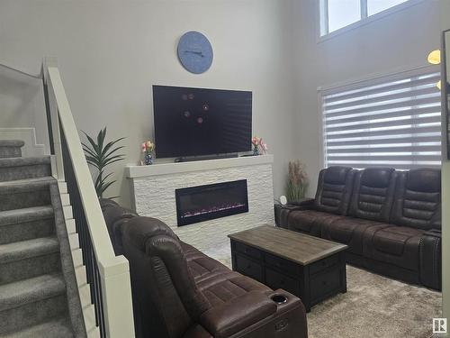 8131 Orchards Green, Edmonton, AB - Indoor Photo Showing Living Room With Fireplace