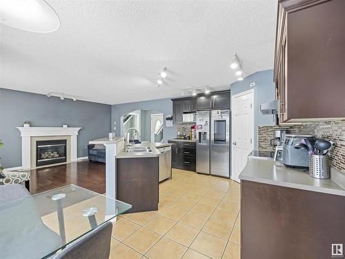 1151 Rutherford Close, Edmonton, AB - Indoor Photo Showing Kitchen With Fireplace