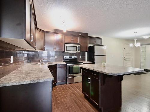 407 6070 Schonsee Way, Edmonton, AB - Indoor Photo Showing Kitchen With Stainless Steel Kitchen With Double Sink With Upgraded Kitchen