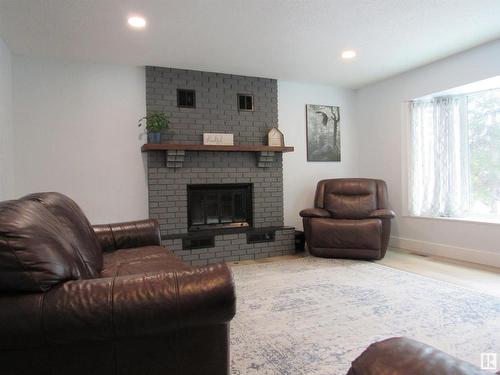 303 57312 Range Road 25, Rural Barrhead County, AB - Indoor Photo Showing Living Room With Fireplace