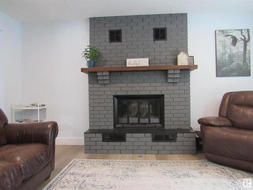 303 57312 Range Road 25, Rural Barrhead County, AB - Indoor Photo Showing Living Room With Fireplace