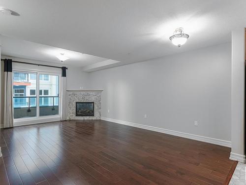 224 10142 111 Street, Edmonton, AB - Indoor Photo Showing Other Room With Fireplace