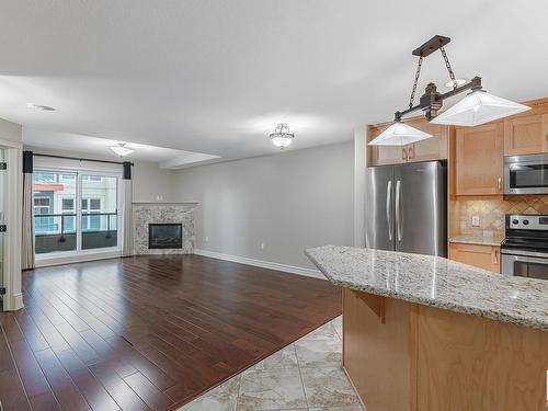 224 10142 111 Street, Edmonton, AB - Indoor Photo Showing Kitchen With Fireplace