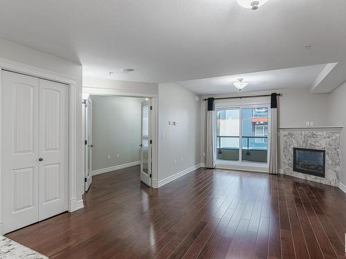 224 10142 111 Street, Edmonton, AB - Indoor Photo Showing Kitchen With Fireplace