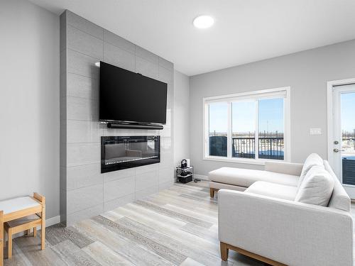 100 Kingsbury Circle, Spruce Grove, AB - Indoor Photo Showing Living Room With Fireplace