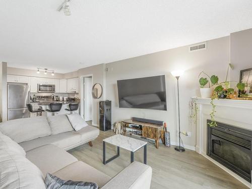 1003 10649 Saskatchewan Drive, Edmonton, AB - Indoor Photo Showing Living Room With Fireplace