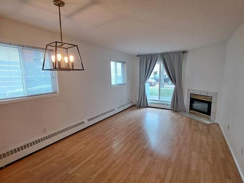 103 10810 86 Avenue, Edmonton, AB - Indoor Photo Showing Other Room With Fireplace