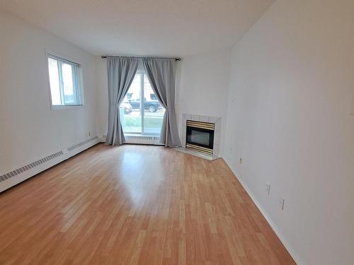 103 10810 86 Avenue, Edmonton, AB - Indoor Photo Showing Living Room With Fireplace