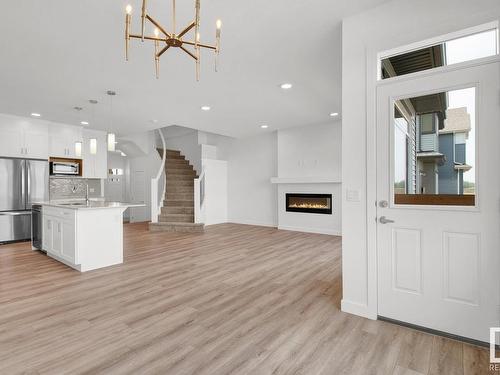 3449 Craig Landing, Edmonton, AB - Indoor Photo Showing Kitchen With Fireplace