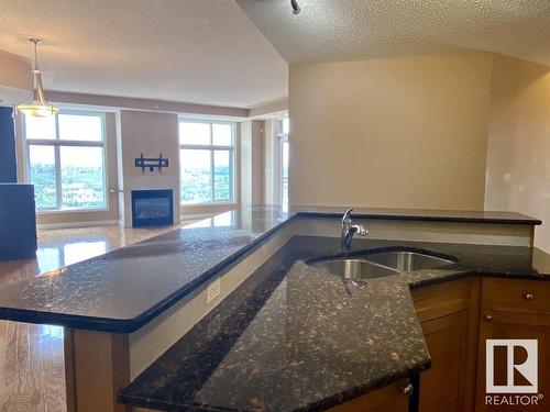 1506 9020 Jasper Avenue, Edmonton, AB - Indoor Photo Showing Kitchen With Fireplace With Double Sink