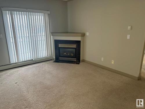 309 4415 48 Street, Leduc, AB - Indoor Photo Showing Living Room With Fireplace