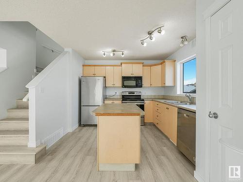 7706 15 Avenue, Edmonton, AB - Indoor Photo Showing Kitchen With Double Sink