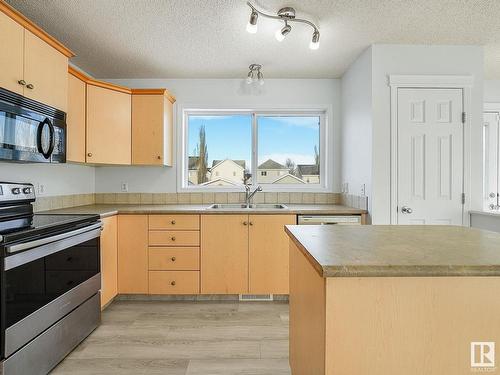 7706 15 Avenue, Edmonton, AB - Indoor Photo Showing Kitchen With Double Sink