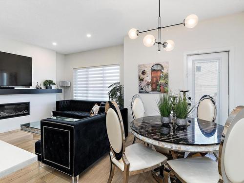 8032 174A Avenue, Edmonton, AB - Indoor Photo Showing Dining Room With Fireplace