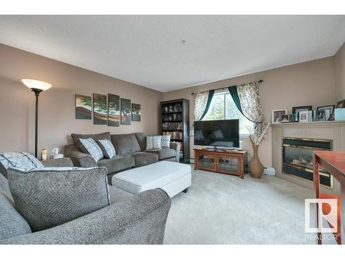 215 17459 98A Avenue, Edmonton, AB - Indoor Photo Showing Living Room With Fireplace