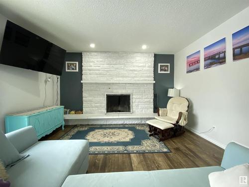 6928 21 Avenue, Edmonton, AB - Indoor Photo Showing Living Room With Fireplace