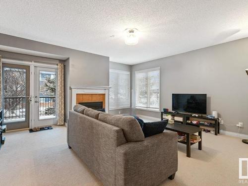 201 9803 96A Street, Edmonton, AB - Indoor Photo Showing Living Room With Fireplace