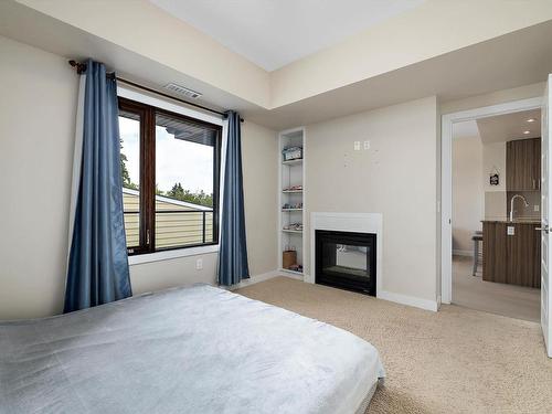 302 10140 150 Street, Edmonton, AB - Indoor Photo Showing Bedroom With Fireplace