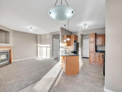 104 Westerra Boulevard, Stony Plain, AB - Indoor Photo Showing Kitchen With Fireplace