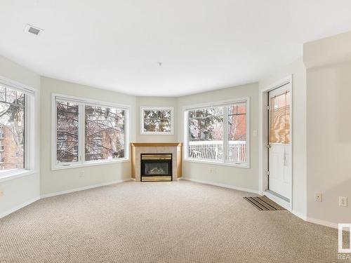 210 8909 100 Street, Edmonton, AB - Indoor Photo Showing Living Room With Fireplace