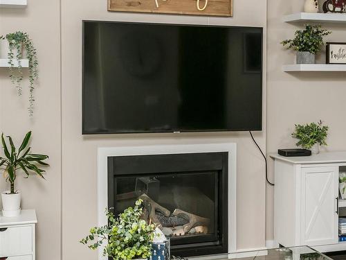 16023 10 Avenue, Edmonton, AB - Indoor Photo Showing Living Room With Fireplace