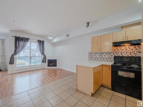 406 10707 102 Avenue, Edmonton, AB - Indoor Photo Showing Kitchen With Fireplace