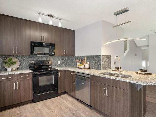 15 4050 Savaryn Drive, Edmonton, AB - Indoor Photo Showing Kitchen With Double Sink With Upgraded Kitchen