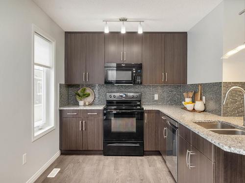 15 4050 Savaryn Drive, Edmonton, AB - Indoor Photo Showing Kitchen With Double Sink With Upgraded Kitchen