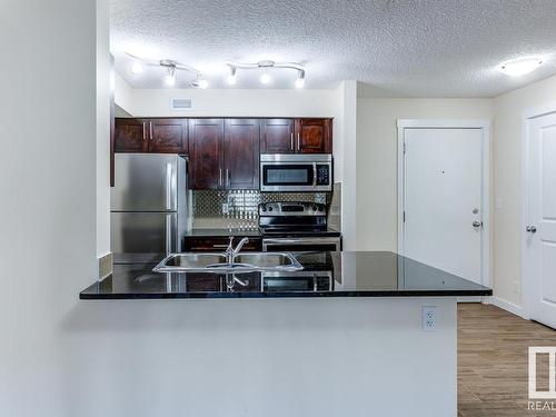 204 5816 Mullen Place, Edmonton, AB - Indoor Photo Showing Kitchen With Double Sink