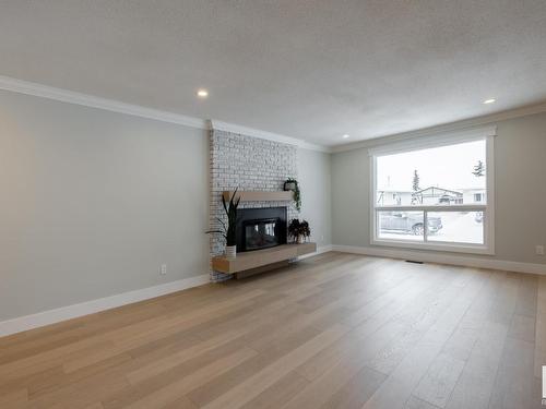 9211 99A Avenue, Morinville, AB - Indoor Photo Showing Living Room With Fireplace