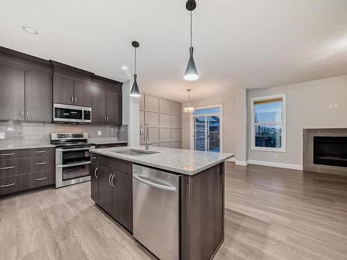 161 Harvest Ridge Drive, Spruce Grove, AB - Indoor Photo Showing Kitchen With Fireplace With Upgraded Kitchen