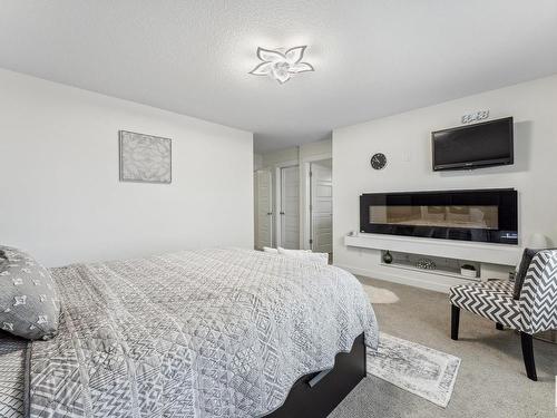 7844 Erasmus Wynd, Edmonton, AB - Indoor Photo Showing Bedroom With Fireplace