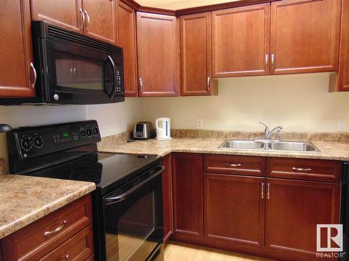 213 8702 Southfort Drive, Fort Saskatchewan, AB - Indoor Photo Showing Kitchen With Double Sink