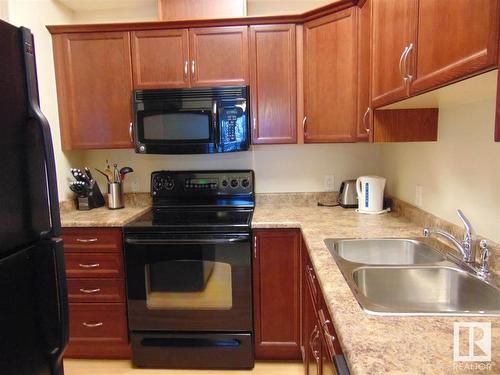 213 8702 Southfort Drive, Fort Saskatchewan, AB - Indoor Photo Showing Kitchen With Double Sink