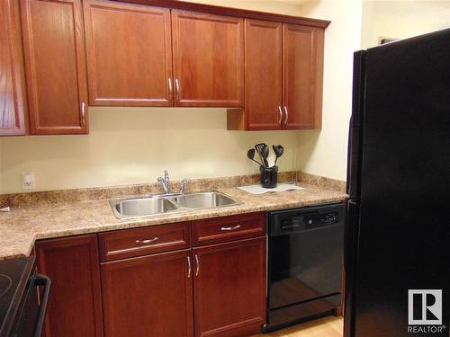 313 8702 Southfort Drive, Fort Saskatchewan, AB - Indoor Photo Showing Kitchen With Double Sink