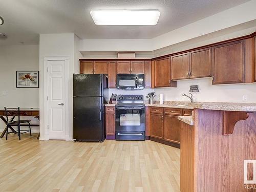 311 8702 Southfort Drive, Fort Saskatchewan, AB - Indoor Photo Showing Kitchen With Double Sink