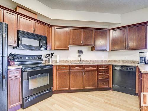 311 8702 Southfort Drive, Fort Saskatchewan, AB - Indoor Photo Showing Kitchen With Double Sink