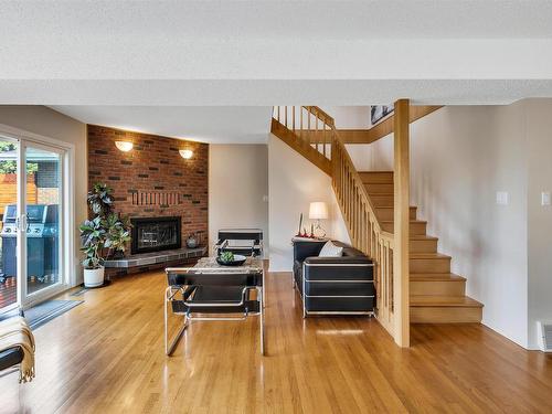 8212 Rowland Road, Edmonton, AB - Indoor Photo Showing Living Room With Fireplace