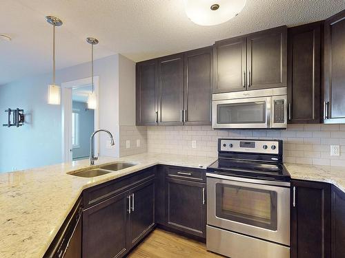 Edmonton, AB - Indoor Photo Showing Kitchen With Stainless Steel Kitchen With Double Sink With Upgraded Kitchen